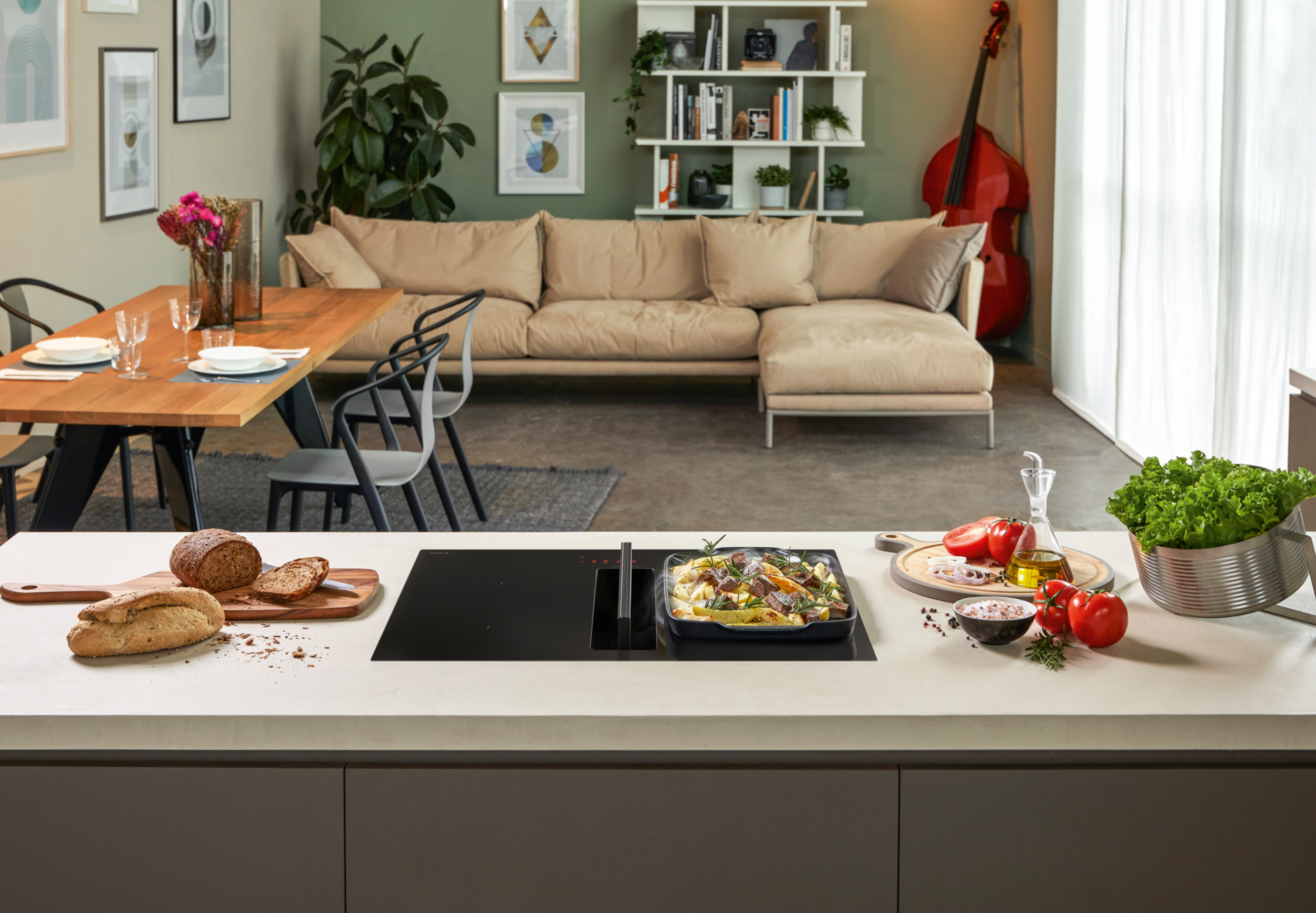 Induction hobs with an integrated cooker hood